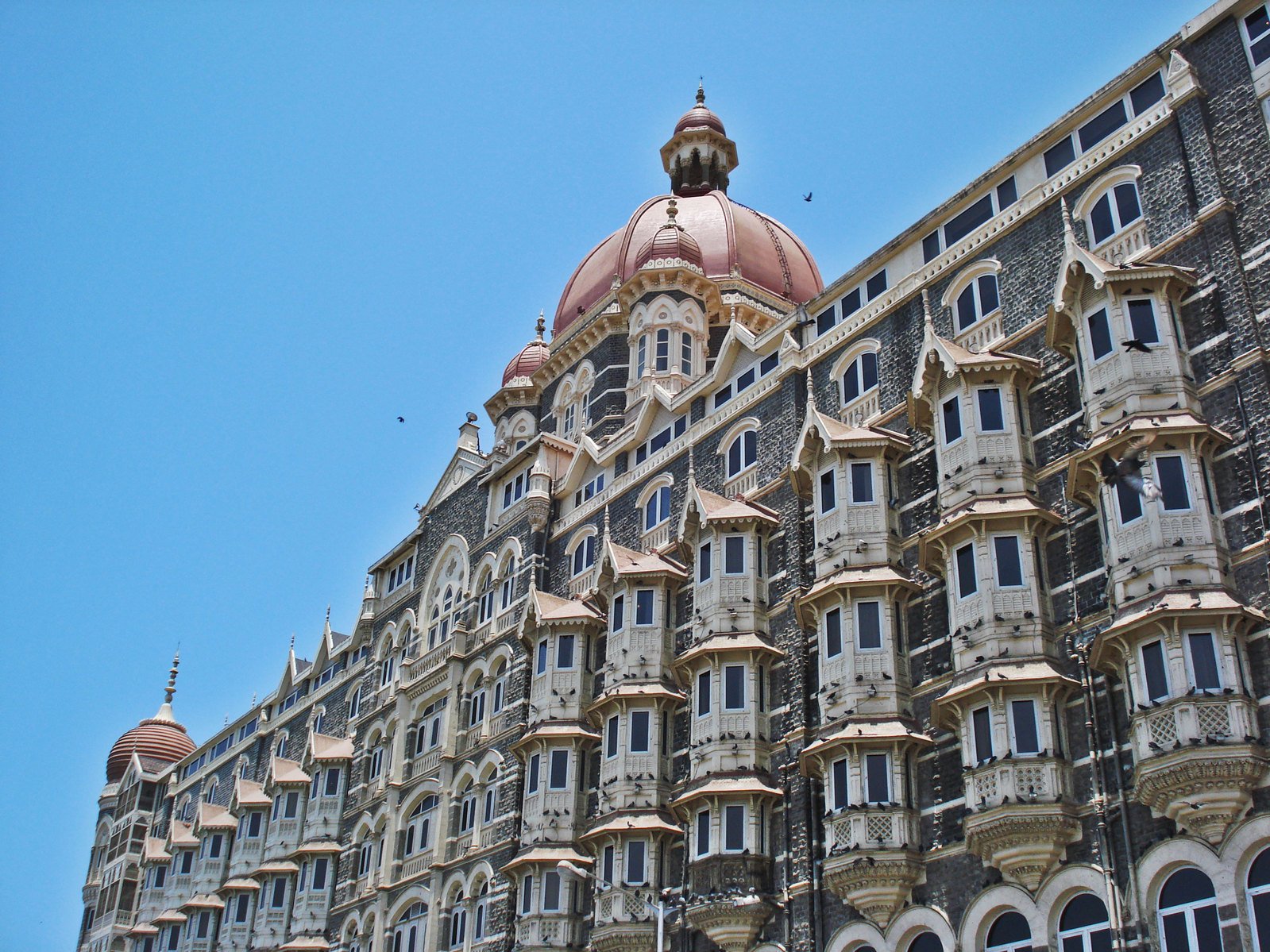 an ornate building that is sitting below a sky