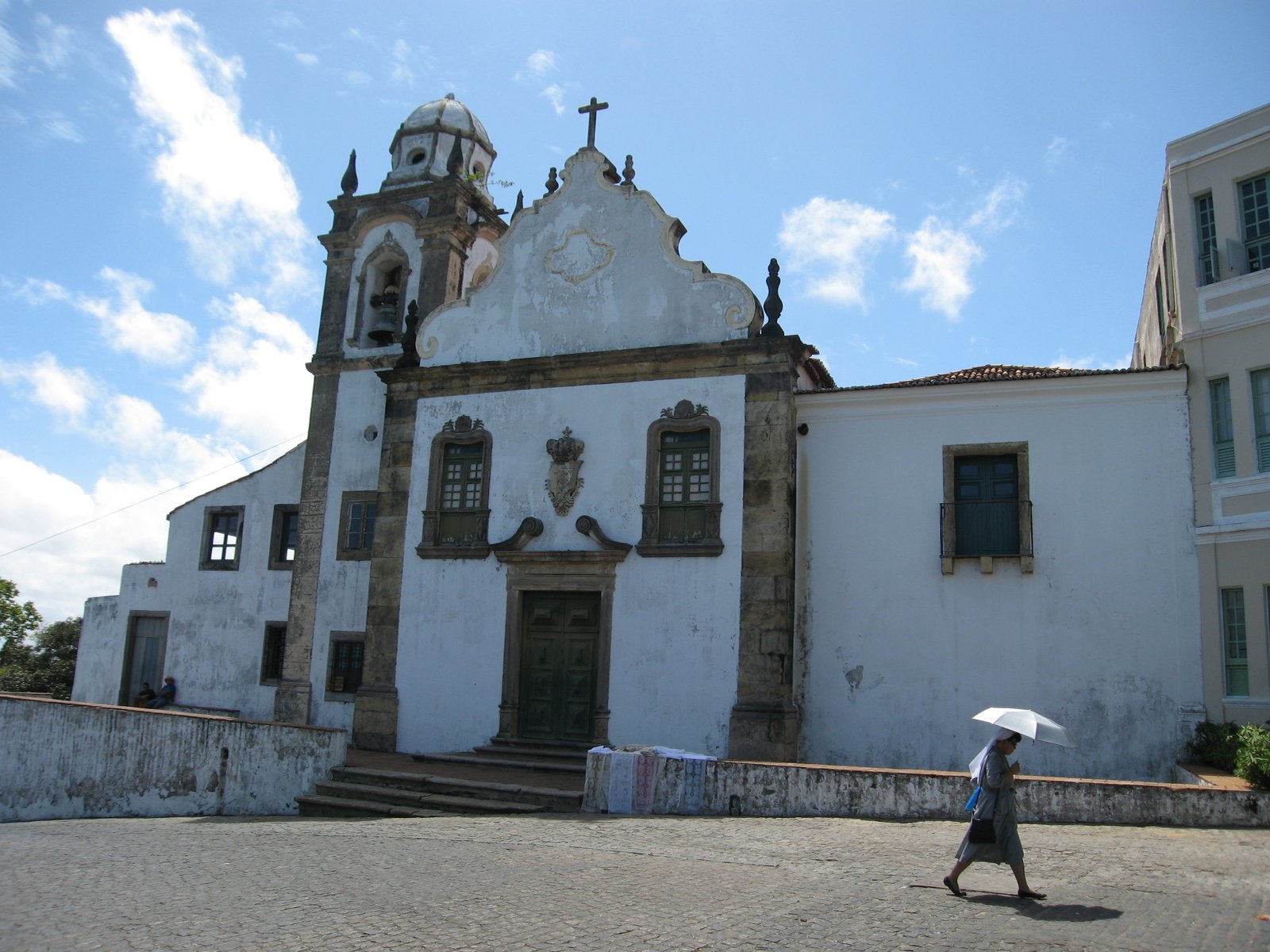 an older church with a tall tower and crosses above it