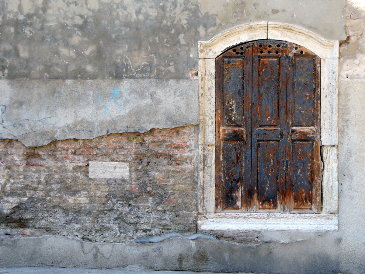 an old building with an open wooden door