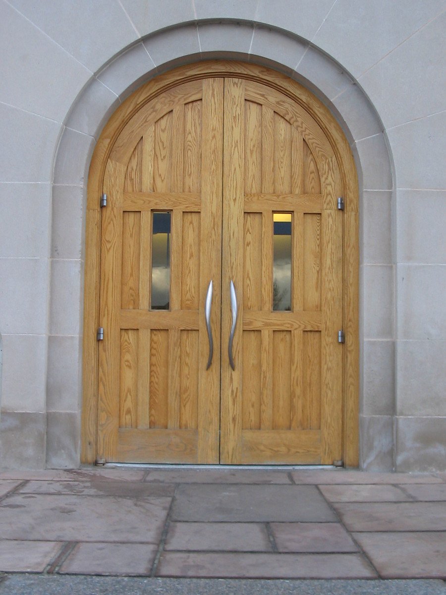 a stone block sidewalk with doors and windows