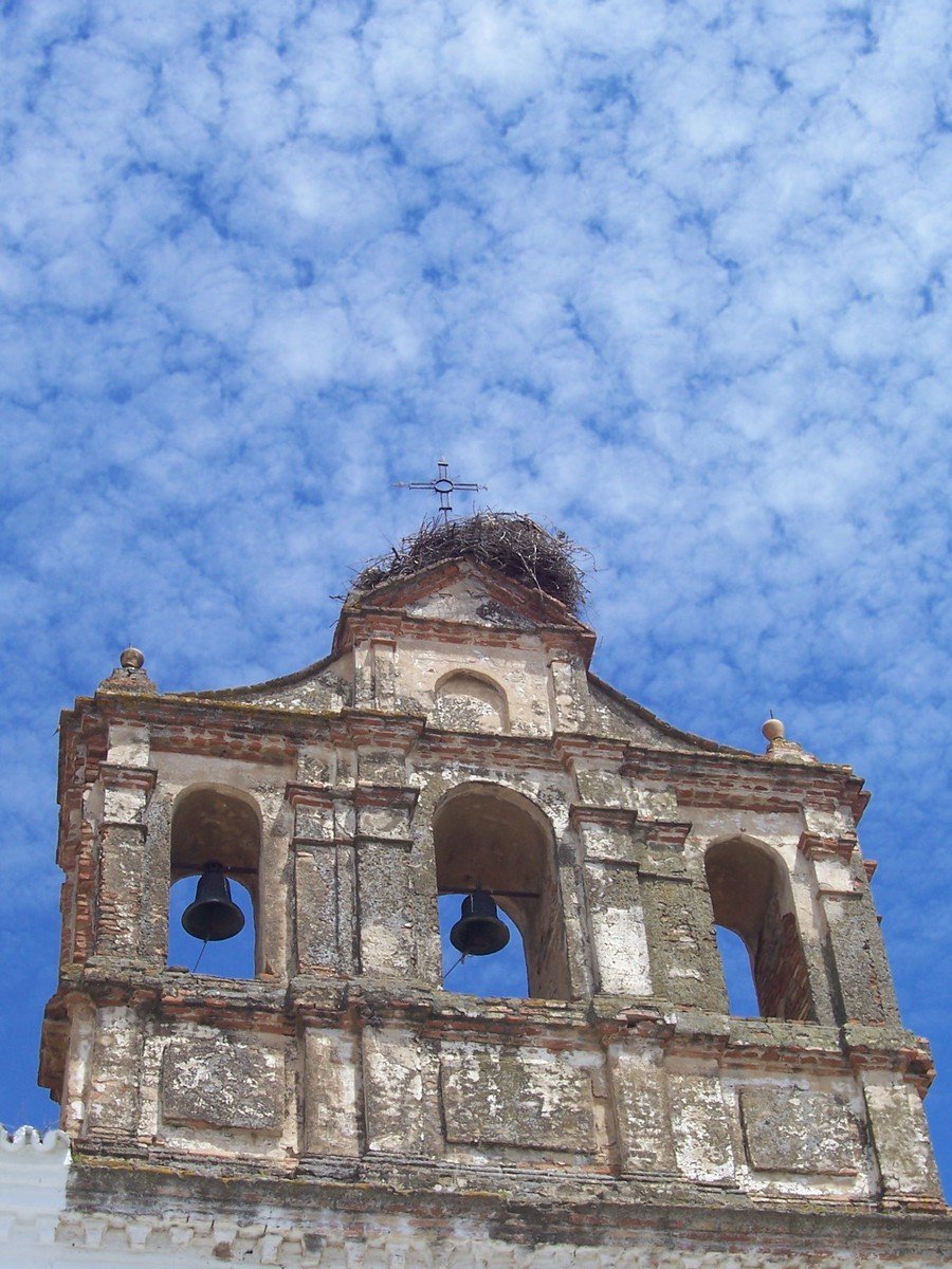 an old building with three bells on the top