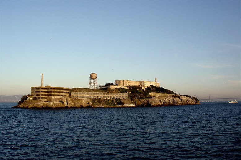 a large building sitting on top of an island in the middle of the ocean
