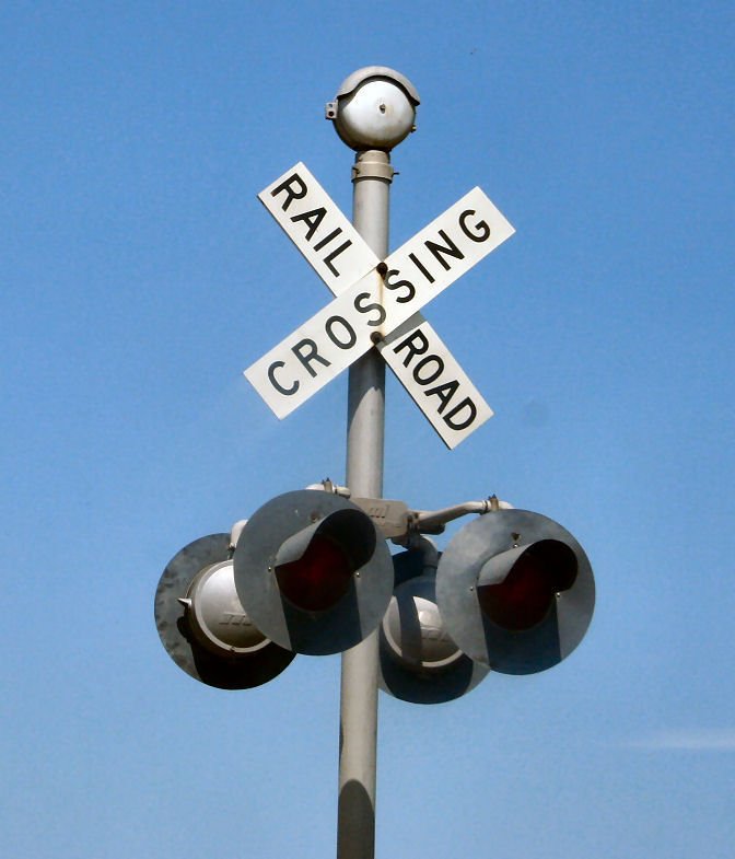 a pole that has a street sign and traffic lights on it