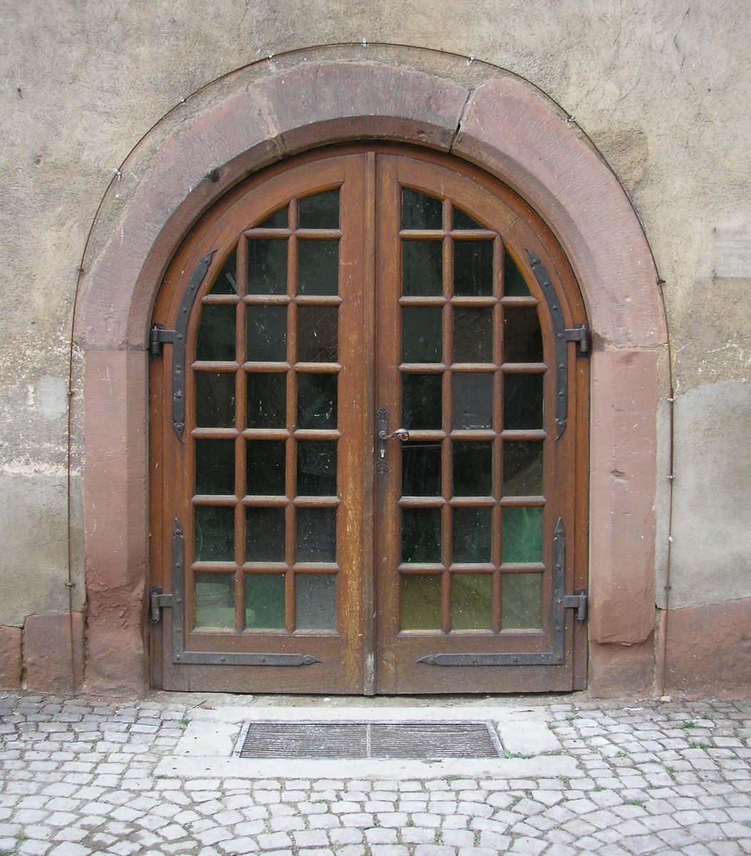 the two arched doors have glass over them