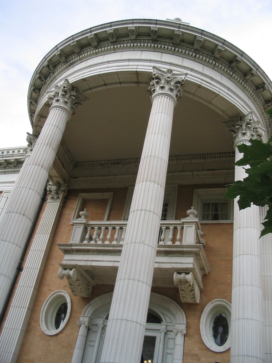 an architectural building with white columns and windows