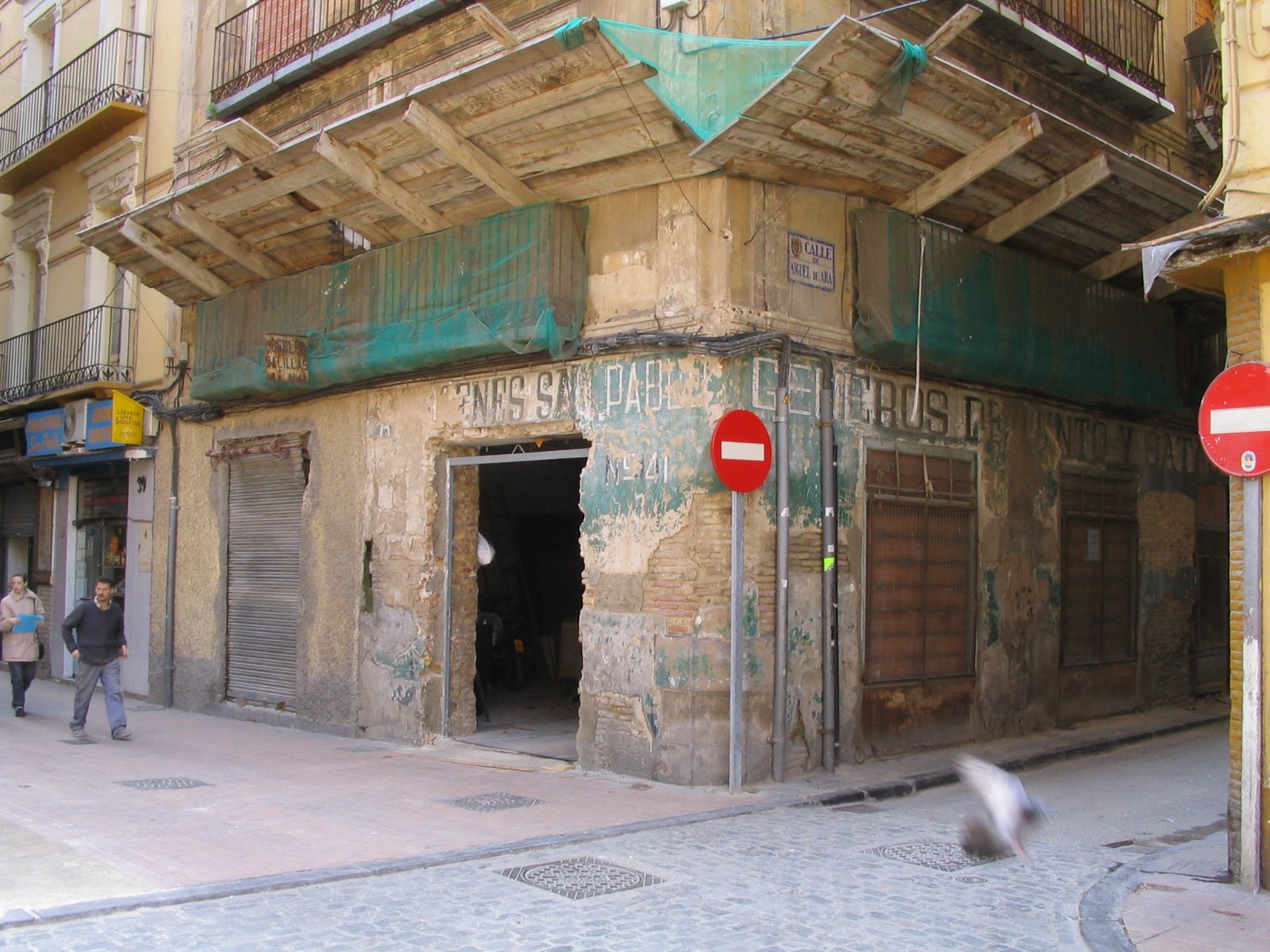 an old building in an alley between two stores
