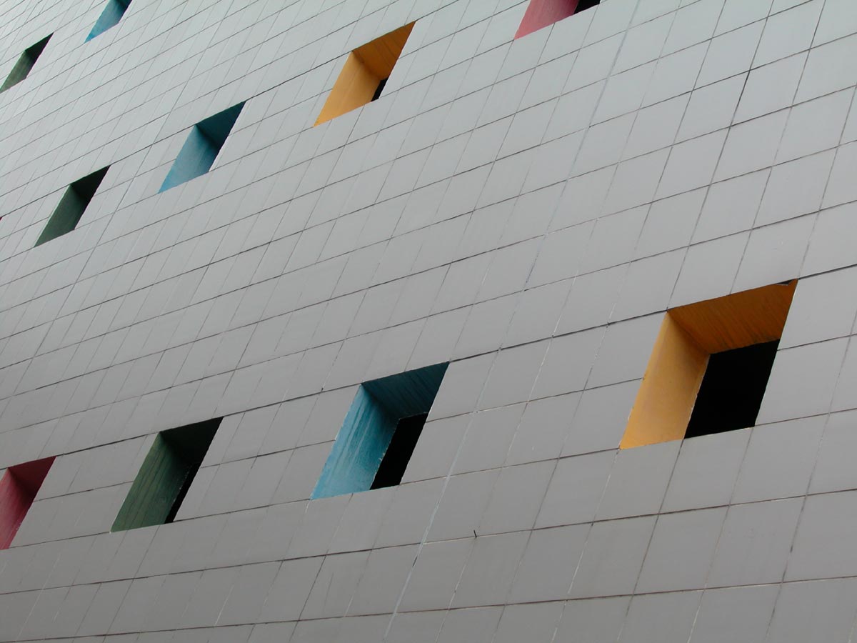 the facade of a building painted with multicolored windows