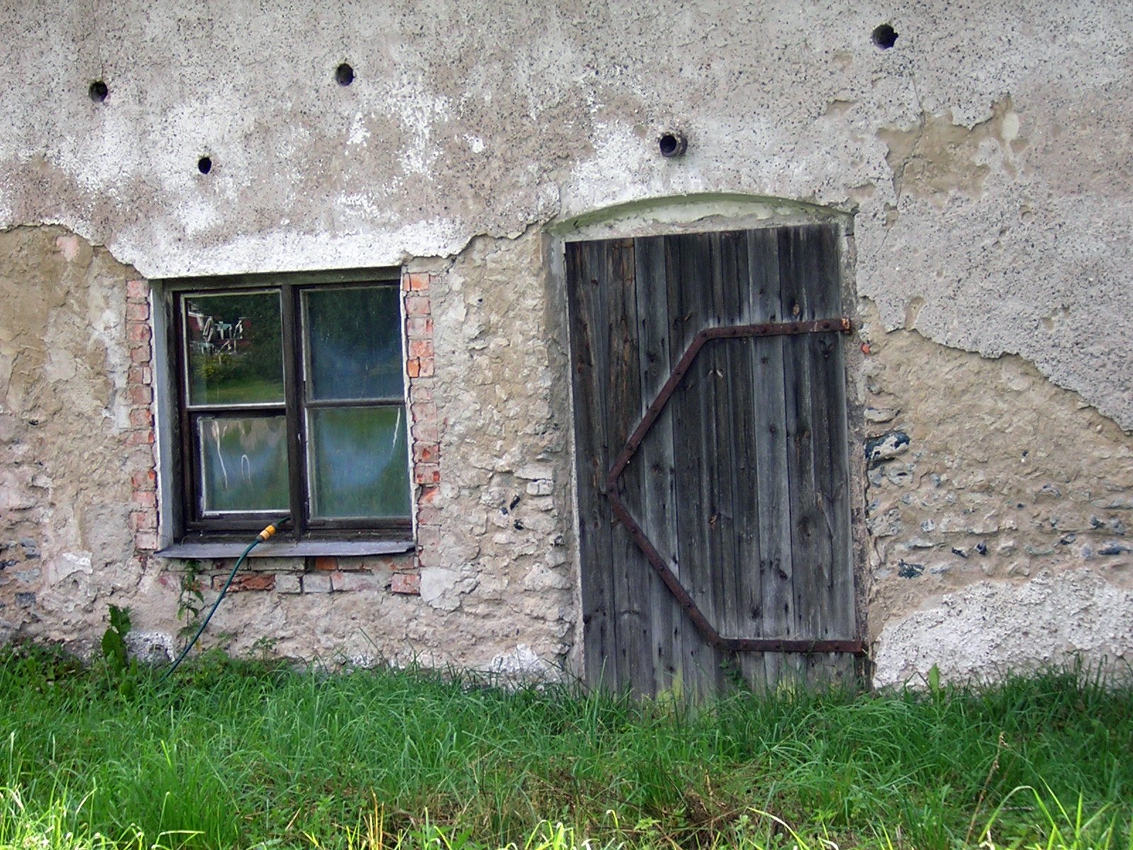 a rustic looking building with an old sliding window