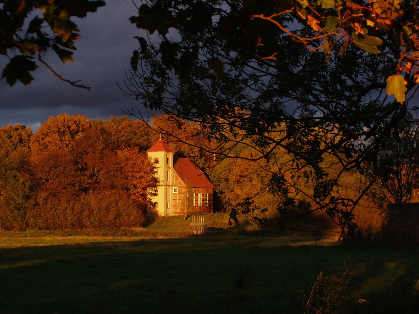 a house sits in a rural setting on an autumn day