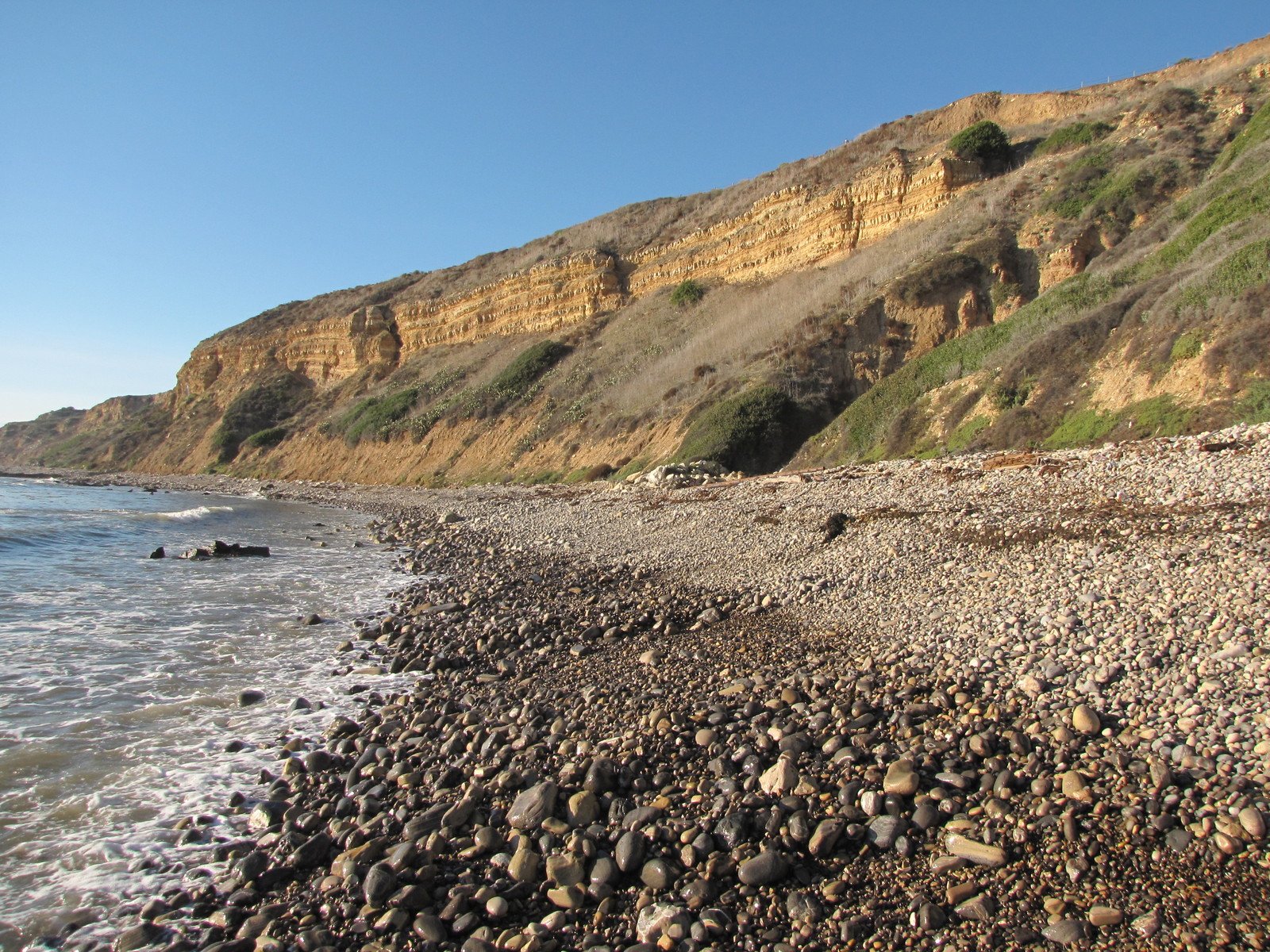 a rocky beach area with water and rocks