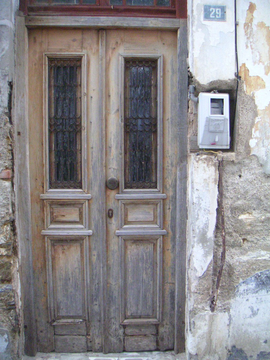 a door in an old building with an air conditioning unit