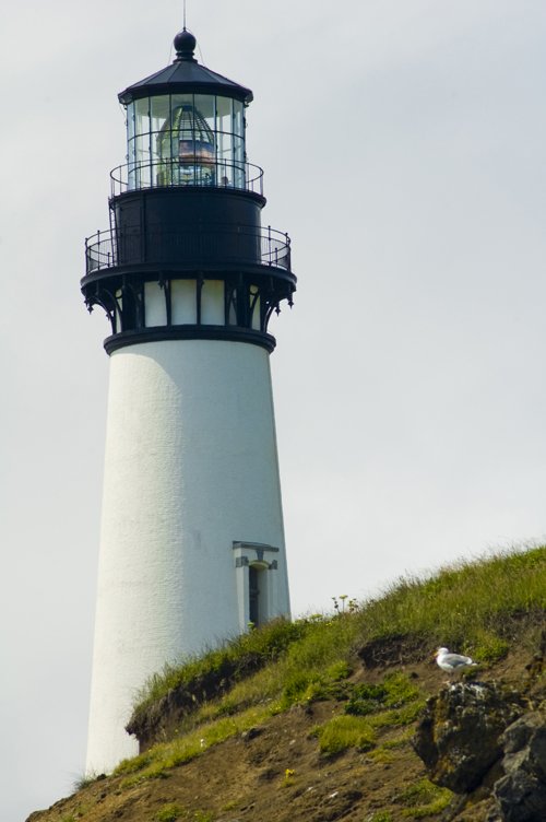 there is a lighthouse on top of a hill