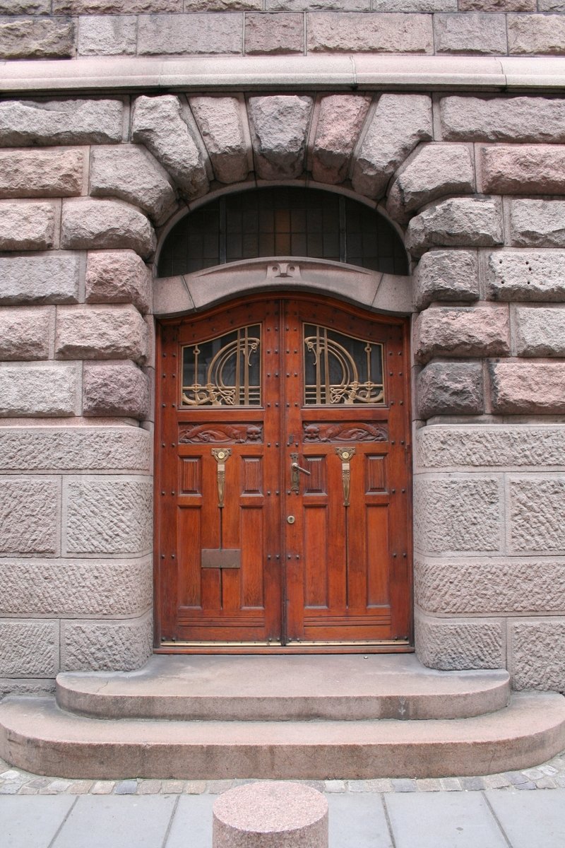 a door on a building with stonework surrounding it