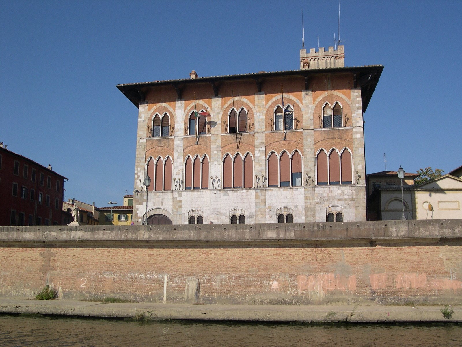 an old building sitting on the side of the river