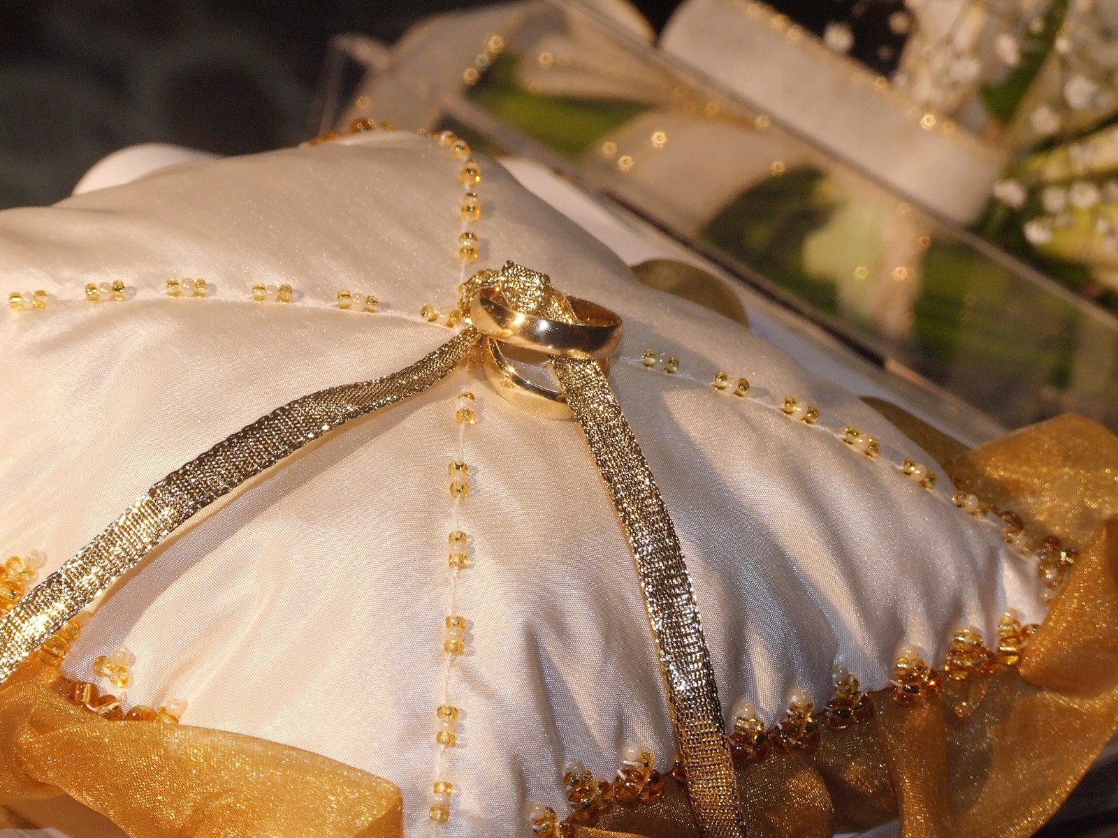a wedding ring on a pillow at a reception