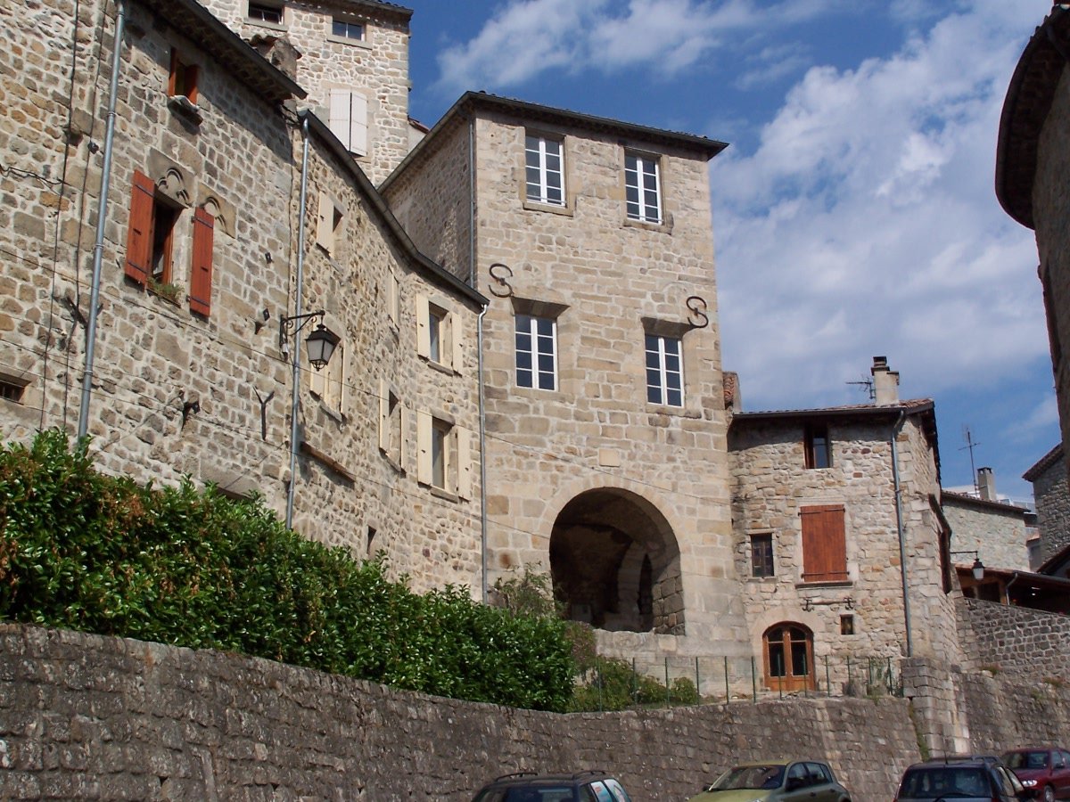 cars parked in front of large stone buildings