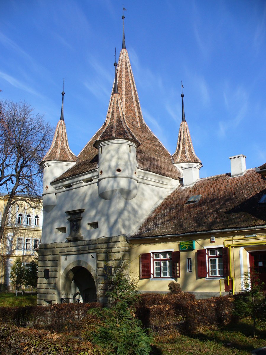 a house with a bell tower and multiple arched roofs