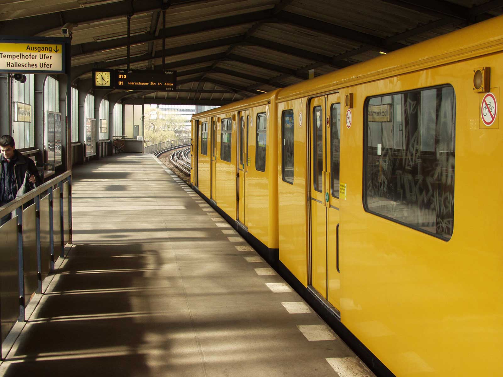 a yellow train parked at a train station