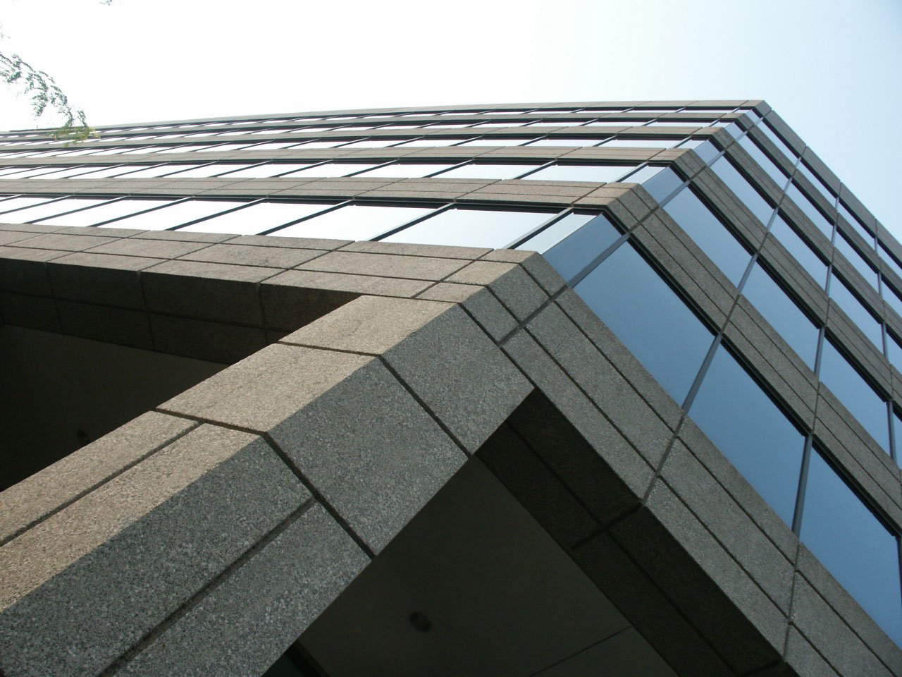 a tall gray building with several windows near by