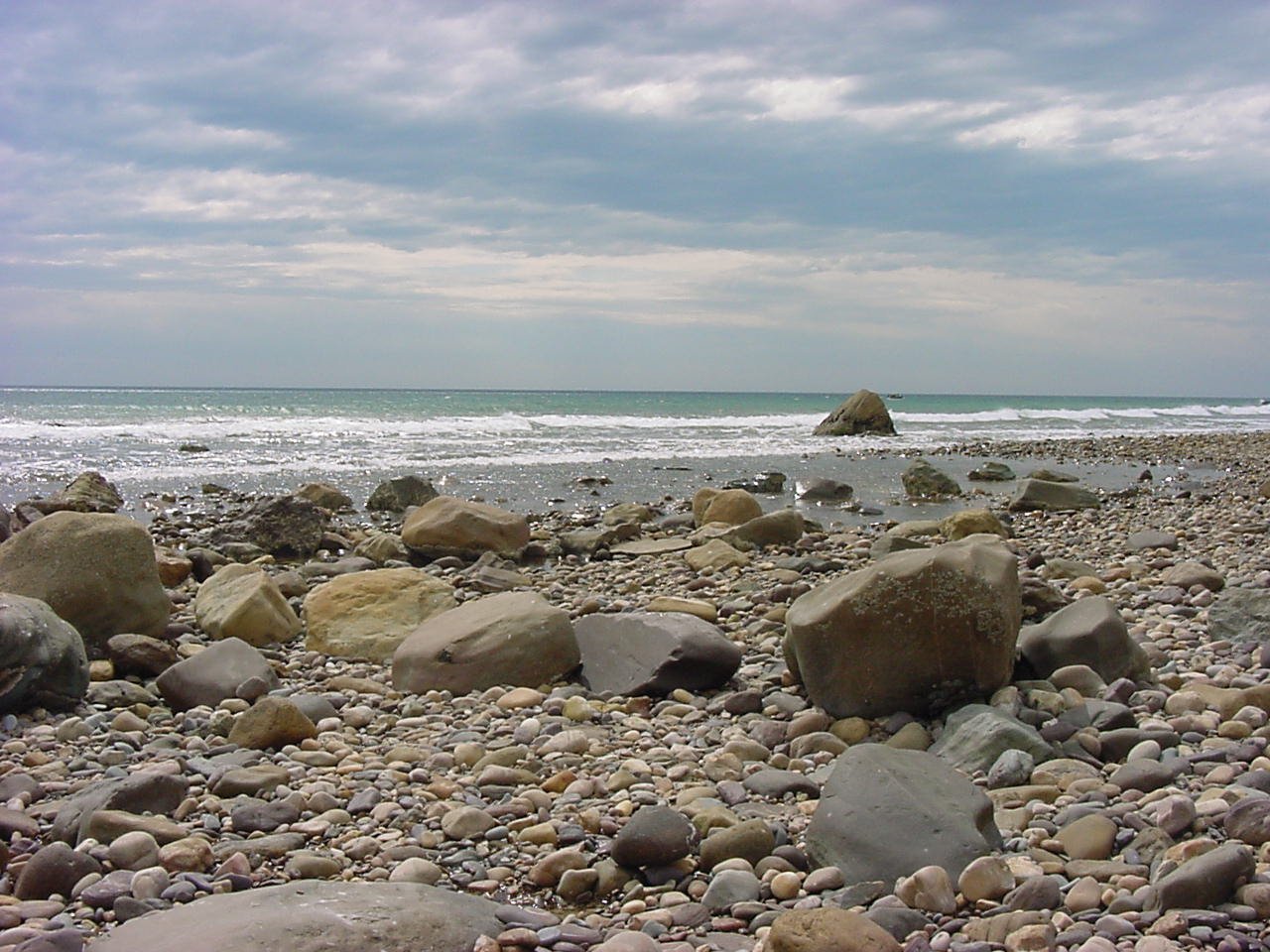 rocks and gravel are arranged on a rocky beach