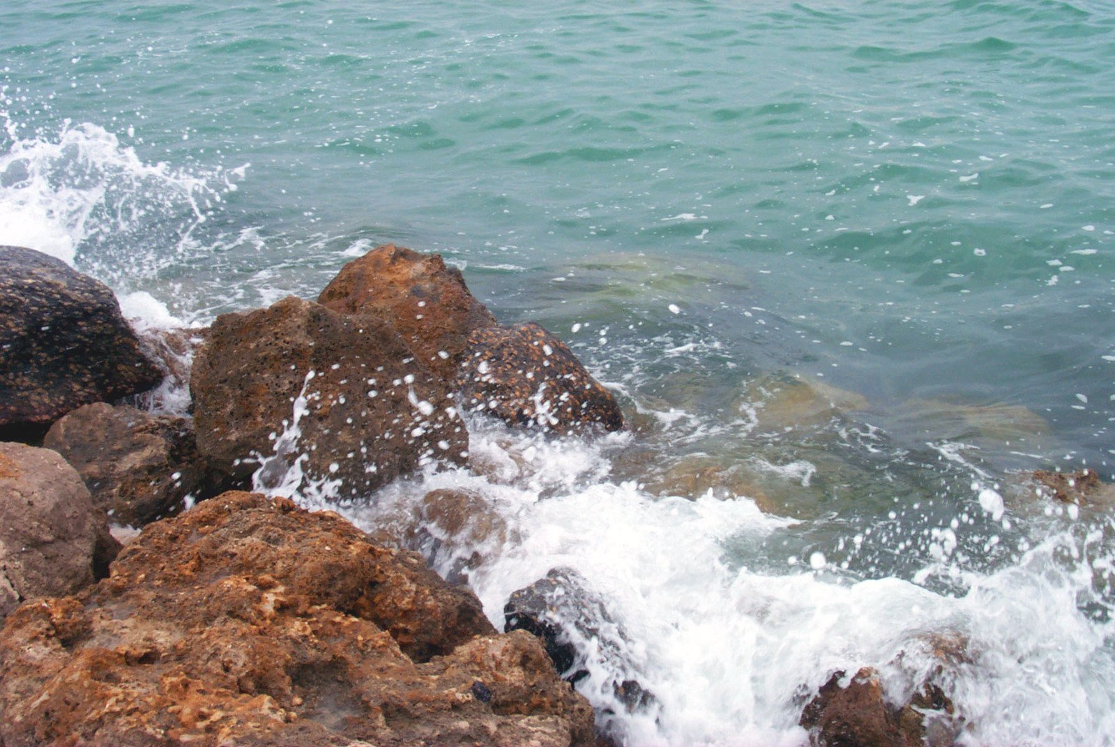 the rocks look like they were splashing out of the ocean