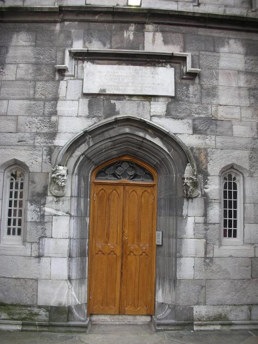 a brown wooden door sitting inside of a stone building