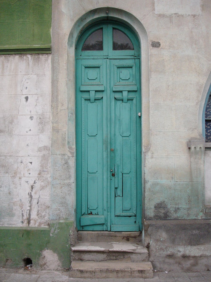 a door on the side of a stone building
