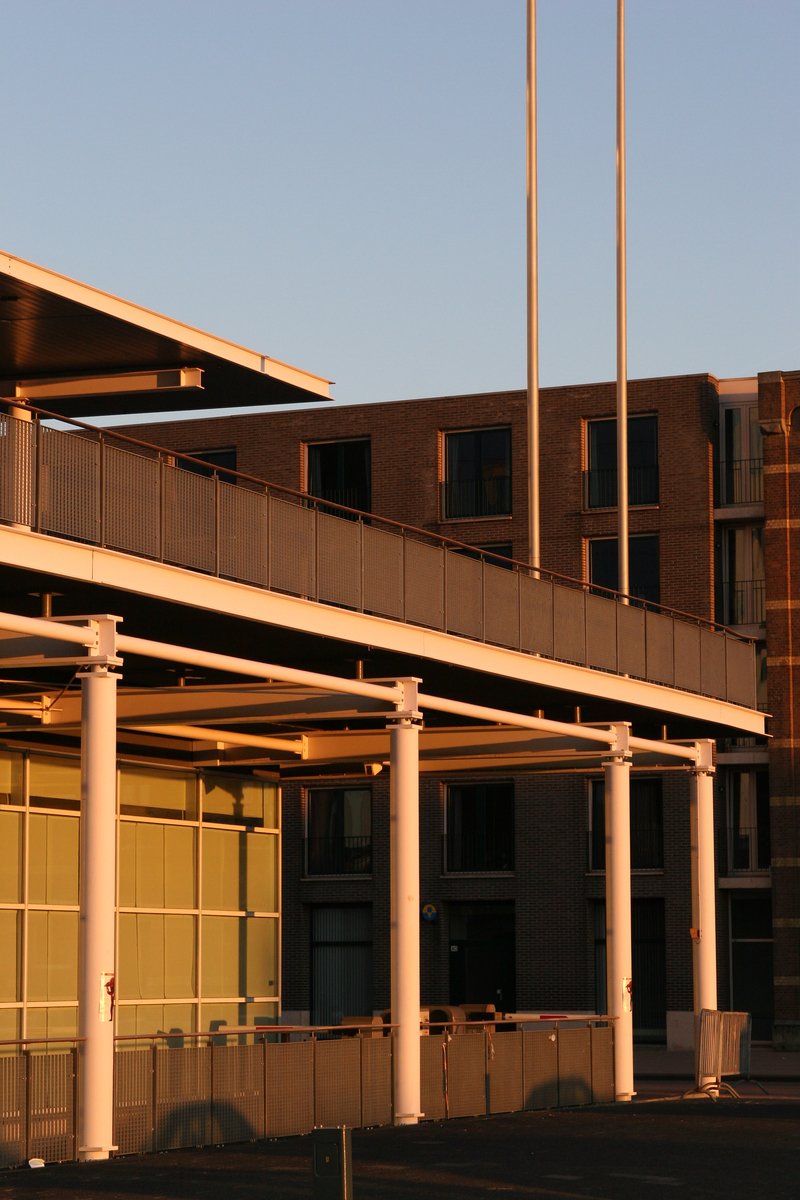 a parking lot and some flags in front of a building