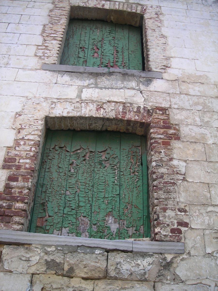 two windows are on an old building