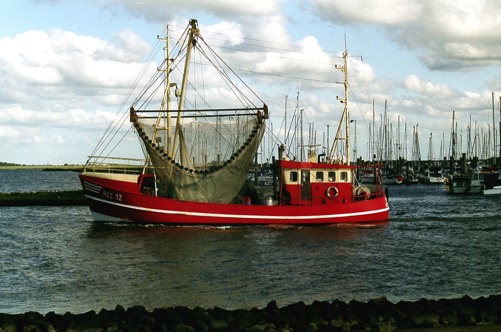 a large red boat sails through the water