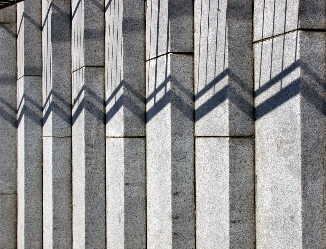 the shadow of several people and their shadows on a wall