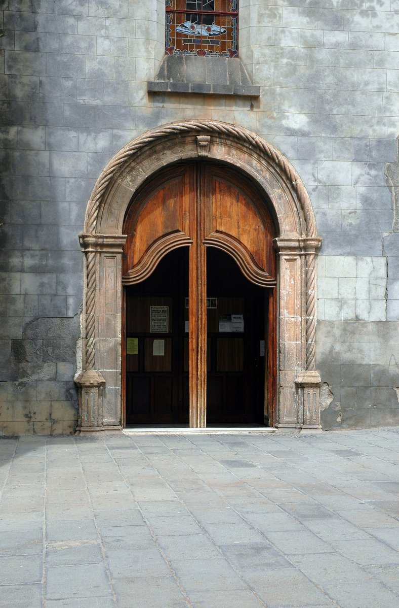 an old looking wooden door in the middle of a stone building