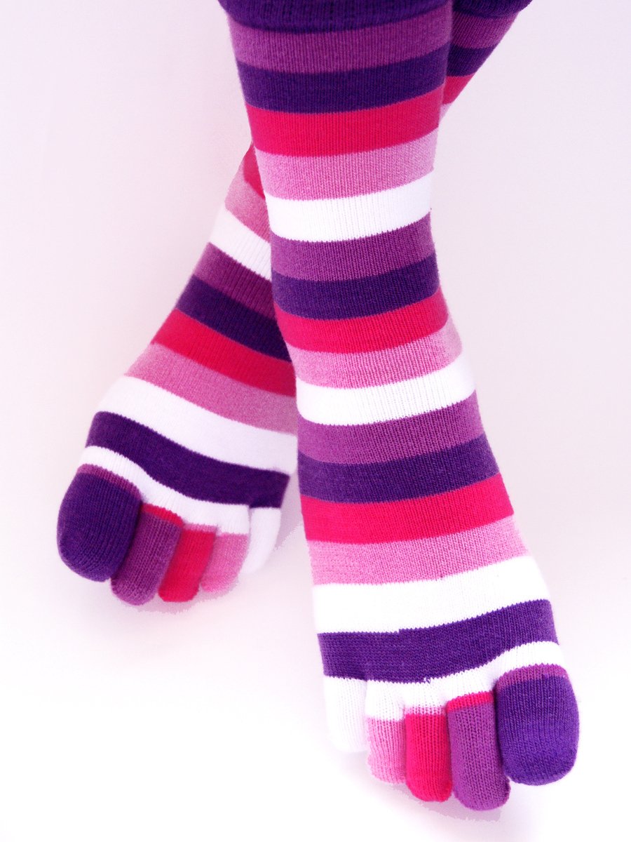 a person with a pair of purple and pink striped socks