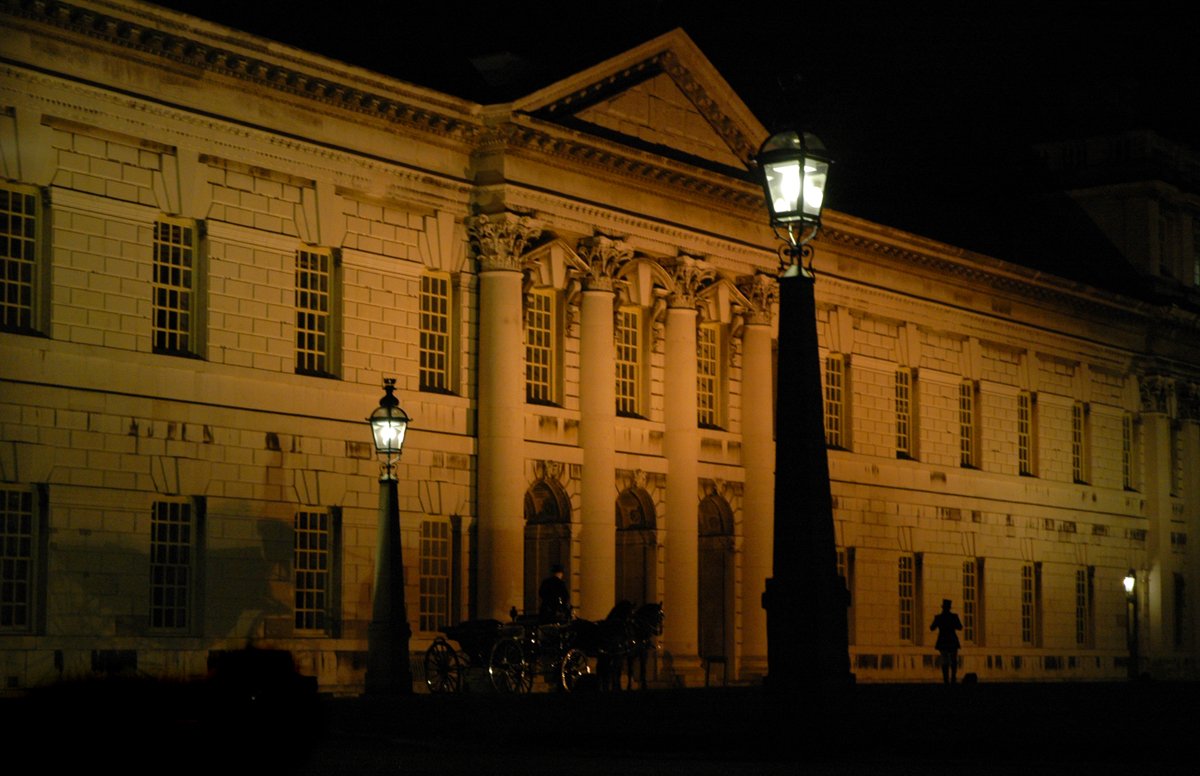 a city street at night with street lamp and building