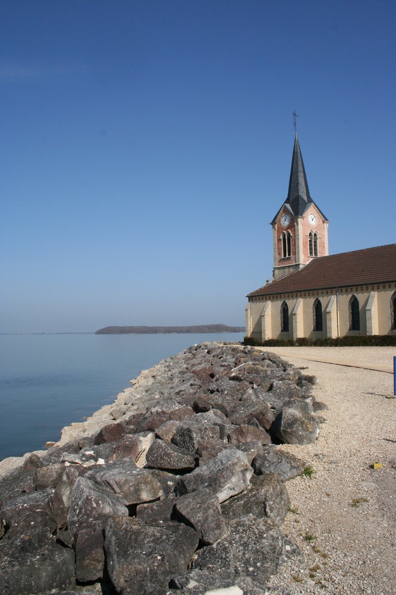 a church sitting on top of a rocky beach