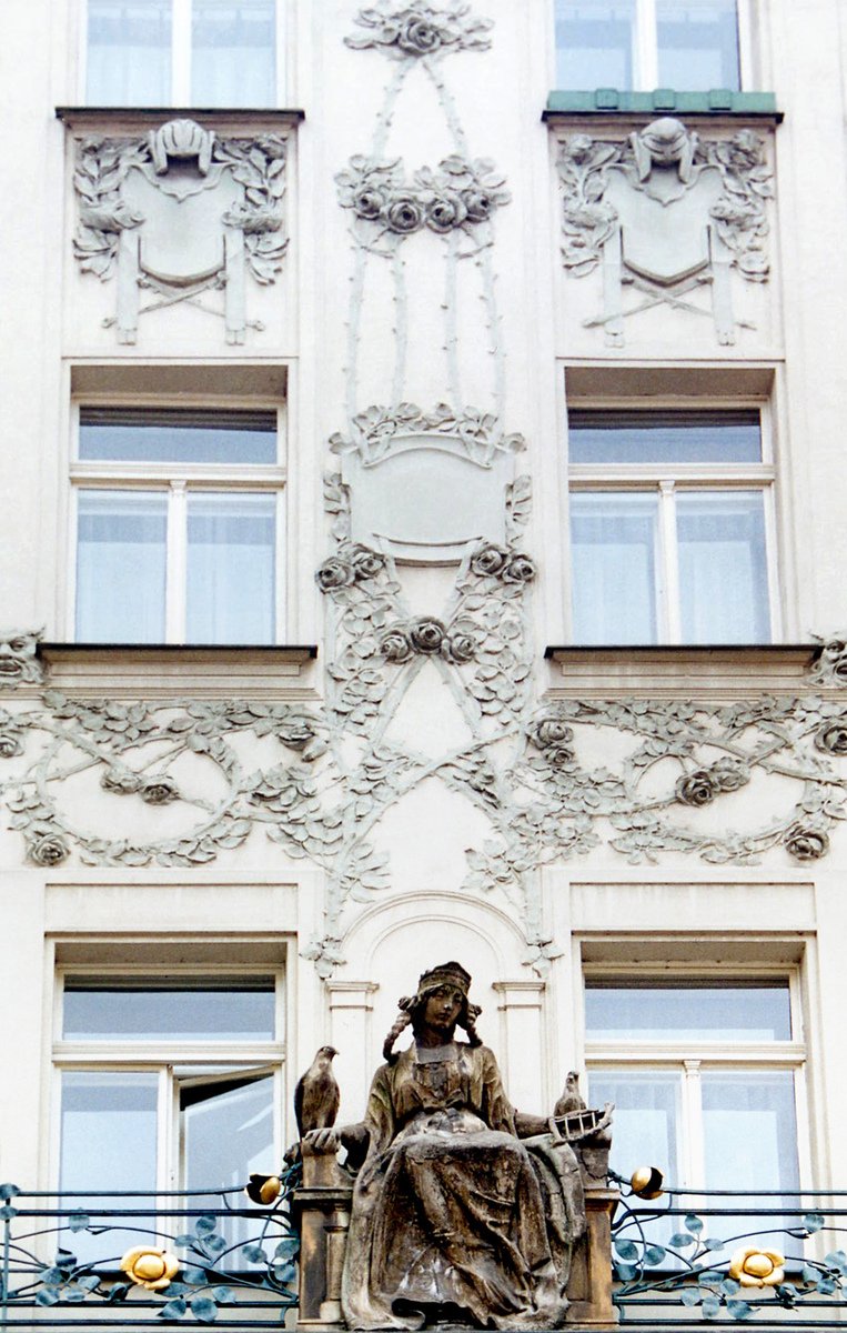 an old statue sitting on top of a building