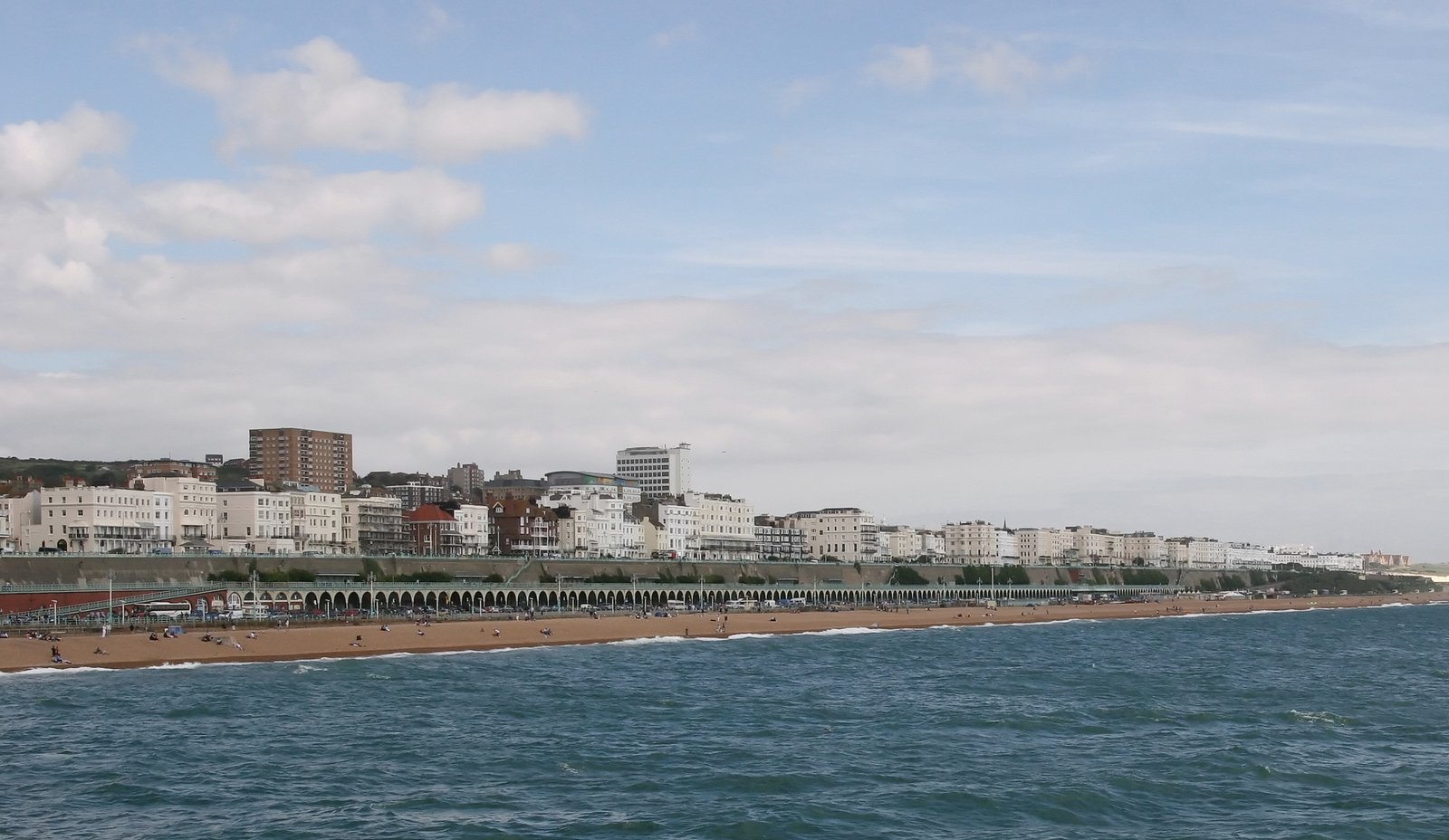 a beach near some tall buildings in the background