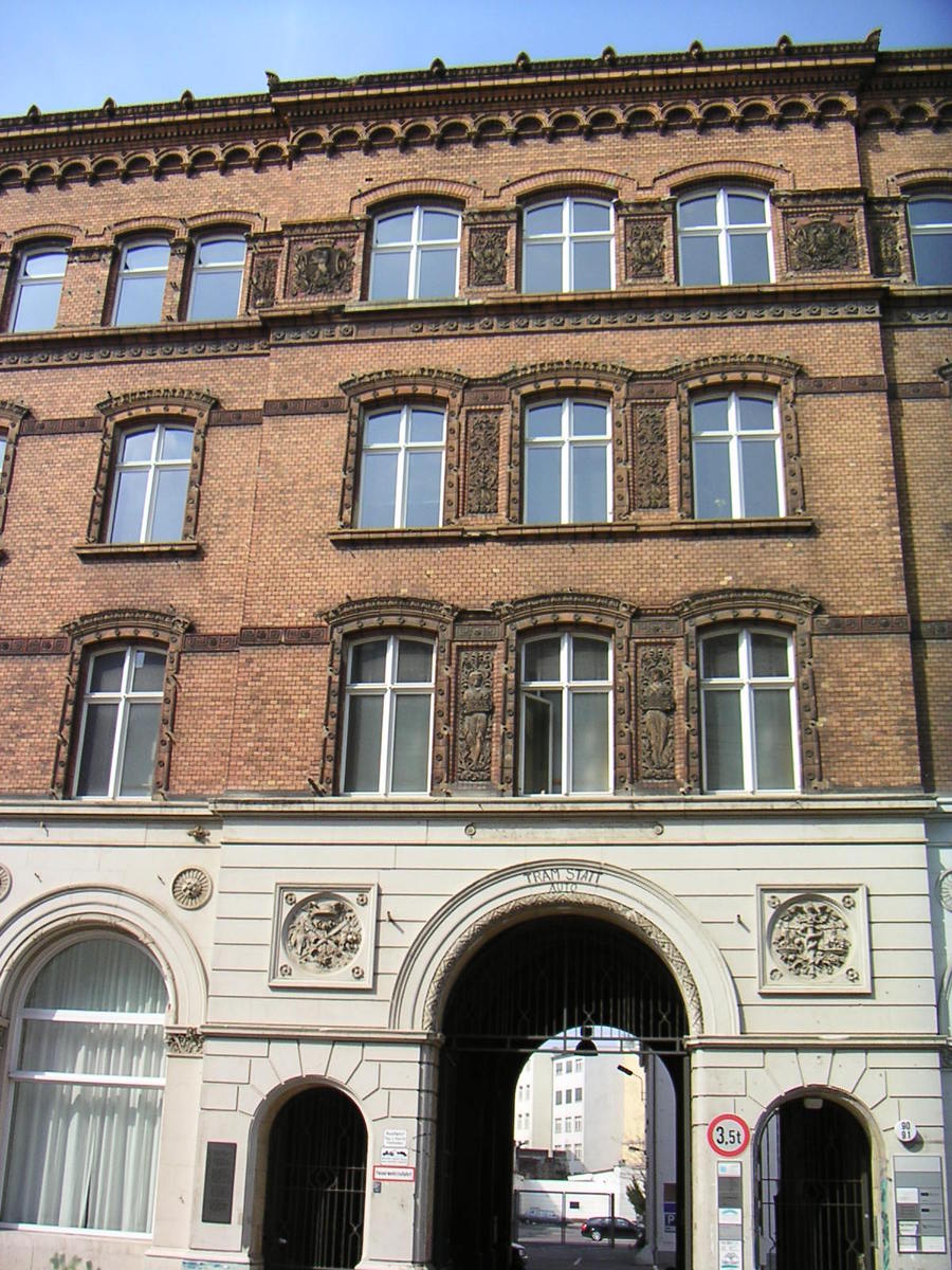 the side of a building with arches and arches on the front