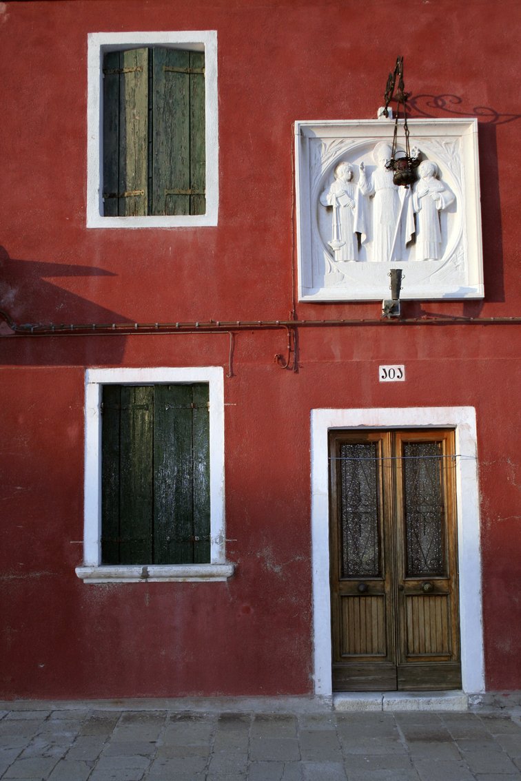 two doors and three windows are on the outside of a building