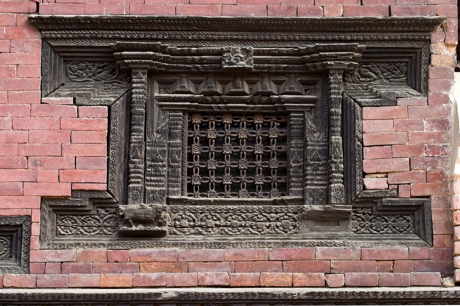 a decorative window on an old brick building