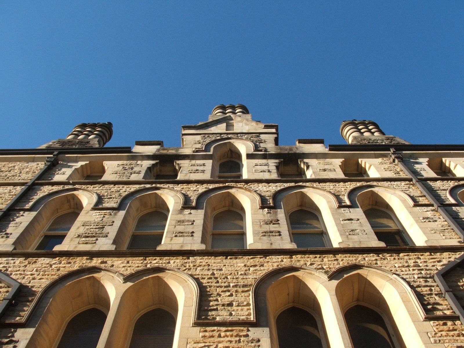 the tower of an old brick building with arched windows