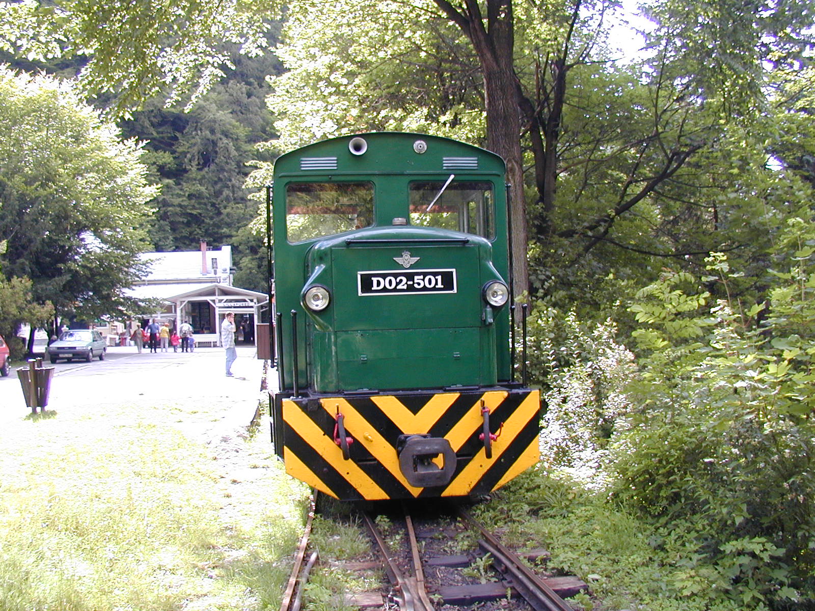 the green train is parked at the station