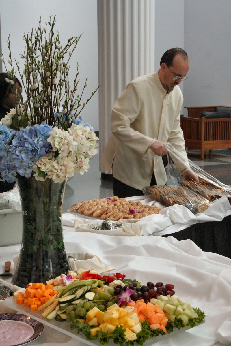 a man preparing food at a buffet table