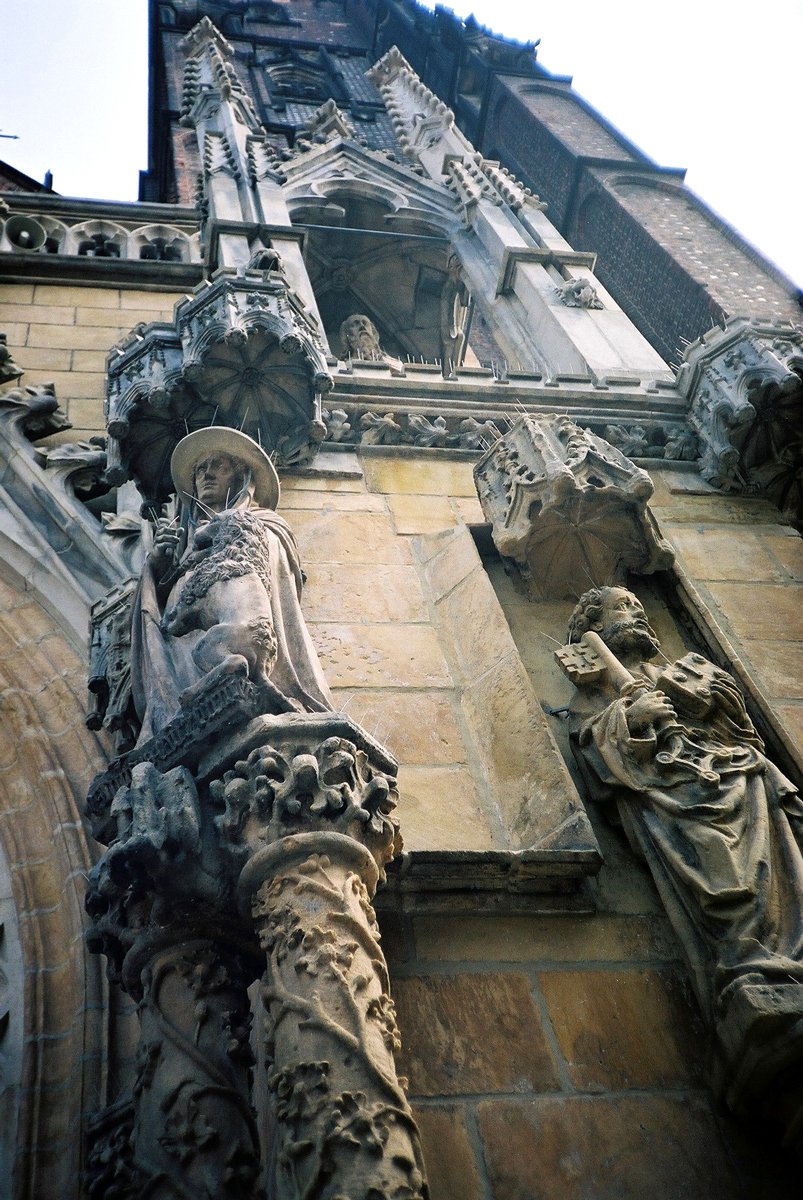 a gothic styled building with gargoyle sculpture on the side