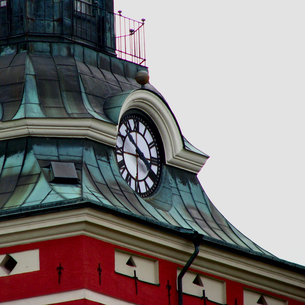 a clock on the top of a tower at dawn