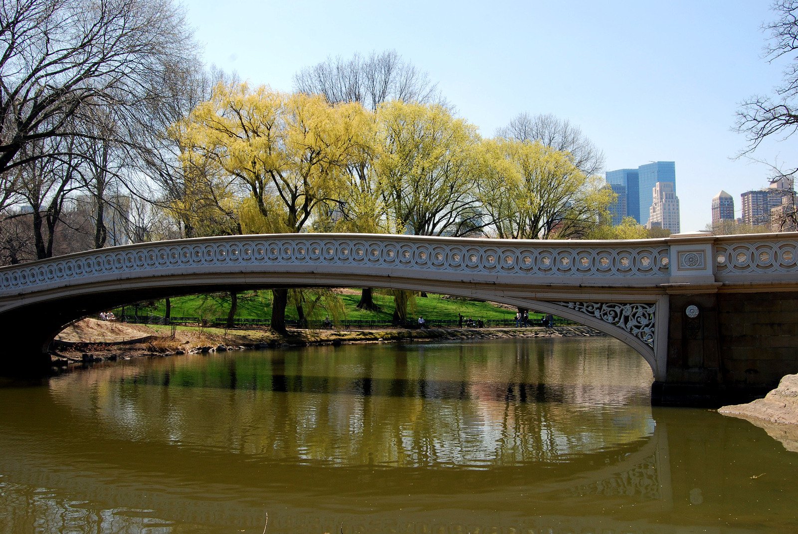 an arched bridge crosses over the small river