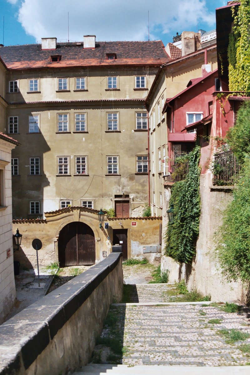 a small building with a clock and some stairs