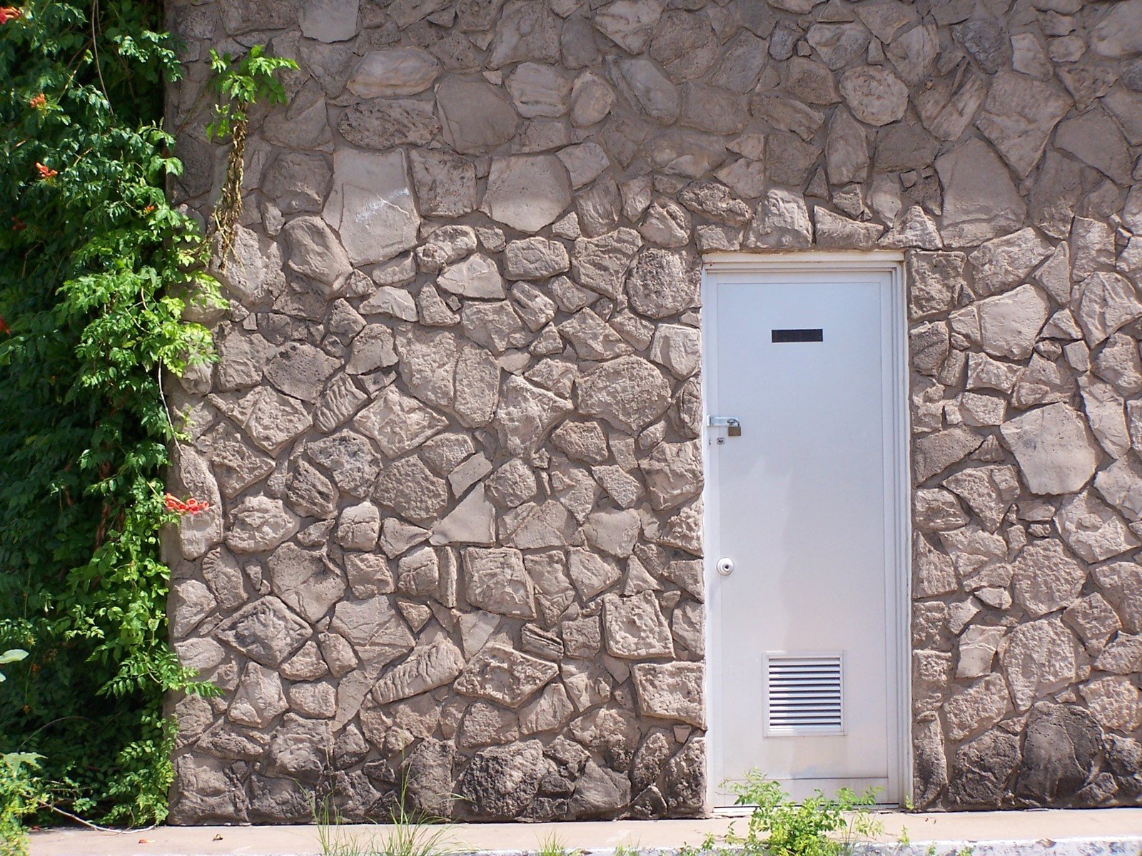 a door that is in between two stone walls