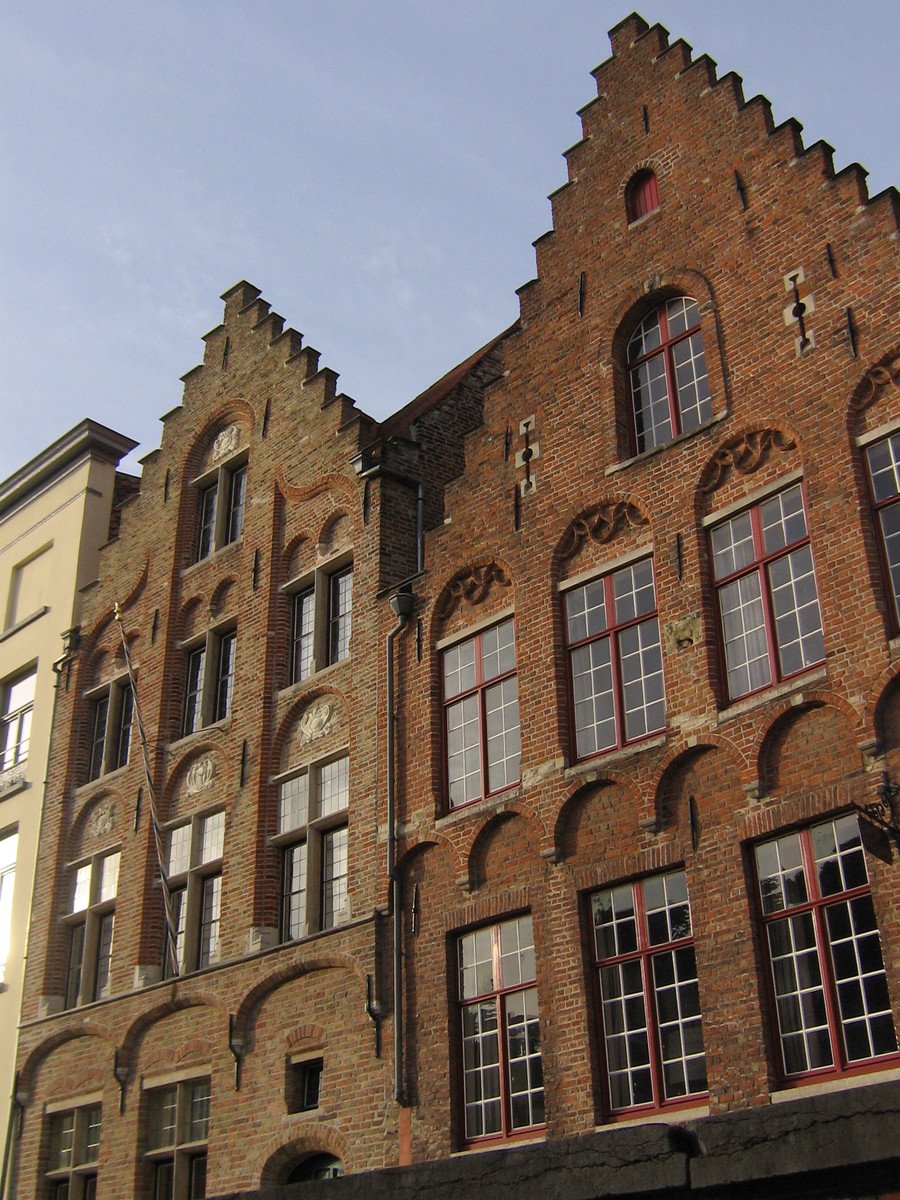 large old building with multiple windows and red accents