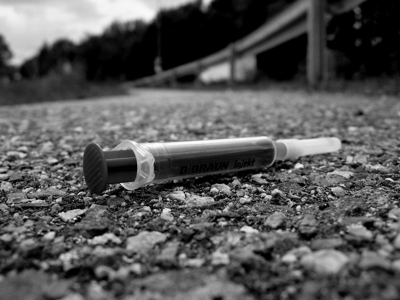 a tube of toothpaste lying in the gravel